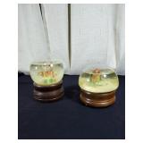 Pair of snow globes one is a music box