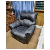 Reclining black chair in well used condition