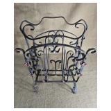 Antique wrought iron magazine rack.
