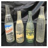 4 vintage pop bottles.
