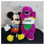 Mickey mouse and Barney stuffed animals