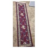 Oriental design rug approx 10 ft long x 2 ft wide