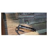 Grease gun and contents on shelf