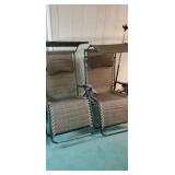 Pair of pool or beach chairs with sun shades