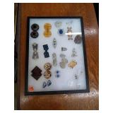 VINTAGE BUCKLES IN A DISPLAY CASE AND SPECTACLES