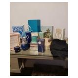 SEVERAL EMPTY AVON BOTTLES, BOXED, BLACK APRON