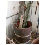 55 GALLON METAL DRUM WITH PIECES OF REBAR AND