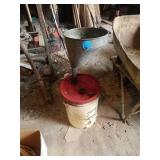 5 GALLON BUCKET, NOT FULL, A FUNNEL