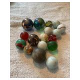 15+ larger marbles, shooters, etc.