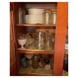 Contents of cupboard, plates, glassware, cookie,