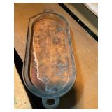Cast-iron griddle 23.5' long, shows wear