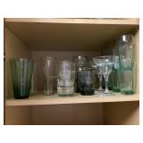 Contents of kitchen shelf- misc glasses (green &