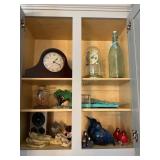Contents of cabinet- decor, clocks,