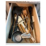 Contents of drawer- wooden utensils, measuring