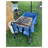 Collapsible wagon shows wear, plastic crate