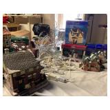 Christmas houses, some lighted, trees, light cords
