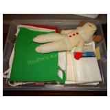 Aprons, pillow cases, lamp chop puppet in plastic