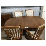 WOODEN TABLE WITH 2 LEAVES AND 4 CAPTAINS CHAIRS