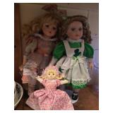 Three Dolls - One has shamrock dress