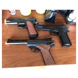 Three Airsoft Pistols and air soft BBs.