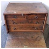 Primitive cabinet with flatware, candles, linens,