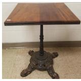 Antique pub table w/ fancy iron base & walnut top