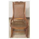 Caned rocking chair with carved eagle decor