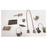 Group of sterling items- note pad, baby rattle,