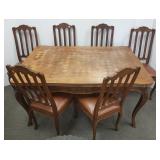Oak carved & inlaid dining room table & 6 chairs -