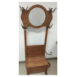 Carved antique oak hall tree with beveled mirror,