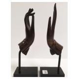 Pair bronze style hand sculptures on composition