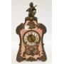 Antique fancy metal clock with figural top