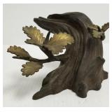 Bronze sculpture of a stamp with leaf branches -