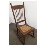 Admiral Dewey pressed back antique rocking chair
