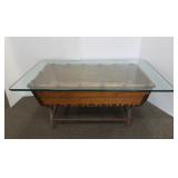Banana boat coffee table with iron base & glass