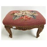 Carved antique foot stool with needlepoint