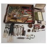 Group of marbles, silverplate flatware, pens, cap