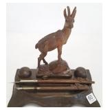 Black Forest carved figural inkwell with pens