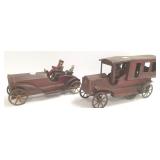 2 antique metal hill climbers with figures- sedan