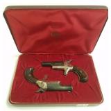 Pair Colt .22 short single shot pistols in fitted