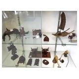 Group of carved wood animal figures, bronze ship