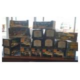 Group of 13 die cast cars in boxes & display cases