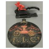 2 metal items: cast iron plaque 11 1/2' diameter &