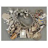 Sterling silver charm bracelet w/ many sterling,