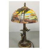 Metal figural lamp with hand painted beach scene
