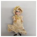 Miniature antique jointed bisque doll with glass
