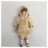 Miniature antique jointed bisque doll with glass