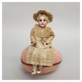 Antique bisque head doll on Easter egg candy