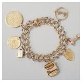 14K gold charm bracelet w/ 7- 14K charms- 34.2g
