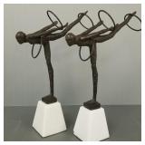 2 matching metal acrobat sculptures on stone bases